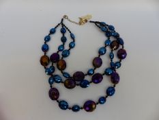 A Butler & Wilson three strand necklace made up of graduating faceted blue beads,