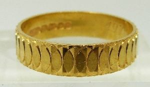 A 22ct gold ring/ wedding band with raised decoration, size N/O, 4.