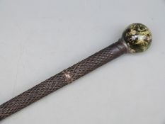 A 19thC walking cane with chequered detail and hardstone spherical knop