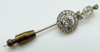 A late Victorian stick pin set with a round cut diamond measuring approximately 1ct within a border