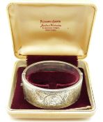 A hallmarked silver bangle with engraved foliate design in original box