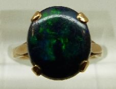 A 9ct gold ring set with a black opal doublet, size J, 2.