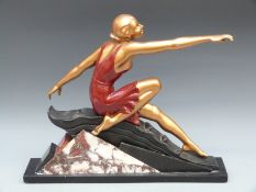 An Art Deco style figure of a lady on geometric base, length 49cm,