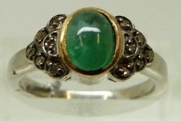 A silver ring set with an emerald cabochon and diamonds, size N/O, 4.