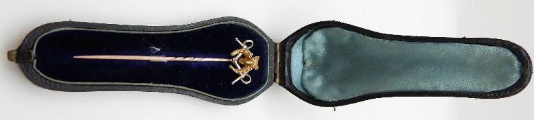 A Victorian stick pin in the form of a fox's head, horseshoe and snaffle bit,