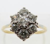 An 18ct gold ring set with seven diamonds in a cluster in a platinum setting,