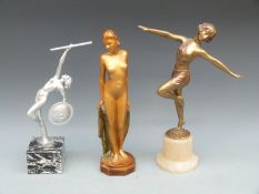 A spelter figure of an Art Deco dancer, a figure of a nude and a nude warrior / dancer,