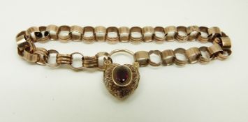 A Victorian bracelet with an engraved heart padlock clasp set with a garnet,