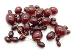 A cherry amber necklace of 48 graduated ovoid beads, largest 28.7 x 21.4mm, 92g.