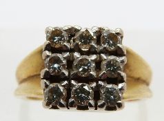 An 18ct gold ring set with diamonds each approximately 0.05ct in a square setting, size H, 5.