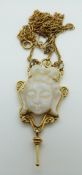 A 9ct gold necklace set with a carved opal Buddha in a scrolled border,