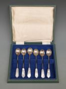 A cased set of hallmarked silver spoons with mother of pearl obelisk finials, Sheffield 1967,