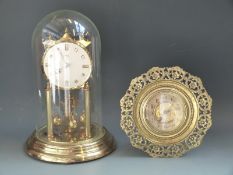 A c1910 circular brass easel clock,