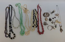 A collection of jewellery including millefiori, cloisonné, silver brooch depicting a bird,