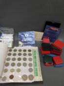 A coin collector's album containing a small collection of coins,