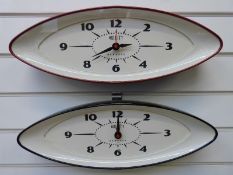 Two Newgate wall clocks in elliptical shaped cased, one red the other black,