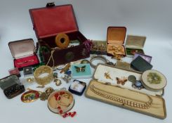 A collection of costume jewellery including brooches, beaded necklaces,