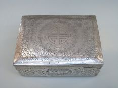 An Eastern white metal wirework box raised on four ball feet,