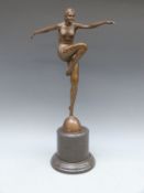 An Art Deco style bronze figure of a female dancer in 1920's attire, raised on a marble base,