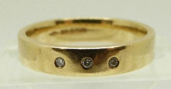 A 9ct gold ring set with three diamonds, size N, 3.