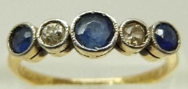 An Art Deco 18ct gold ring set with three sapphires and diamonds, engraved 1927, size P, 2.