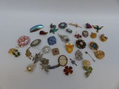 A collection of brooches including Art Deco, ivory, marcasite and enamel, malachite, amber,