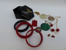 A suite of cinnabar lacquer Chinese jewellery including bangles, necklace, earrings and pendants,