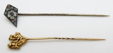 A yellow metal stick pin set with a gold nugget (2.
