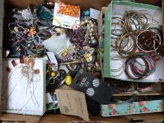 A large collection of costume jewellery including agate beads, tiger's eye pendants, fossil pendant,