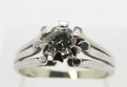 A white metal ring set with a round brilliant cut diamond of approximately 0.