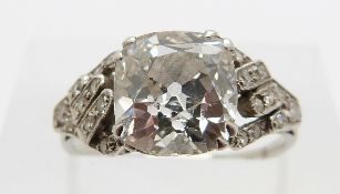 An Art Deco platinum ring set with a cushion cut diamond of approximately 2.