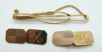 A pair of 9ct gold cufflinks with engine turned decoration and a 9ct gold tie pin, 11.