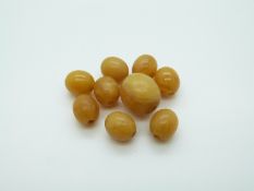 Nine amber beads of butterscotch colour, largest 15.4 x 14.1mm, 8g.