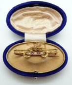 A 15ct gold Victorian brooch set with alternating pearls and red paste,