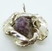 A white metal pendant set with rough amethyst crystal and marked Victor
