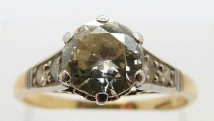 An 18ct gold ring set with a round brilliant cut diamond measuring approximately 0.