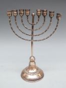 A white metal Menorah candelabra with impressed .