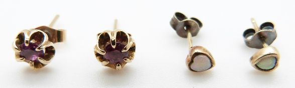 A pair of 9ct gold earrings each set with a ruby and a pair of 9ct gold earrings set with heart