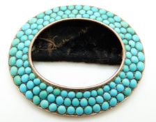 A Victorian gold buckle set with three rows of turquoise cabochons