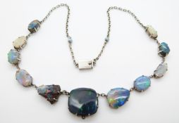 A white metal necklace set with eleven opal cabochons