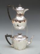 A George V hallmarked silver teapot and hot water jug, of shaped form, Sheffield 1927,