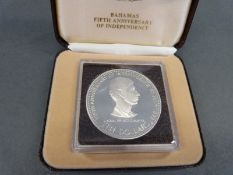 A silver Bahamas 5th Anniversary of Independence ten dollar coin with certificate