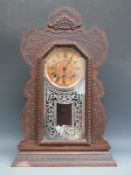 Ansonia late 19thC gingerbread clock with Roman dial, the movement striking on a gong,