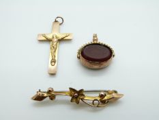 A 9ct gold swivel fob, 9ct gold crucifix and a 9ct gold brooch,