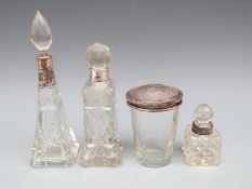 Four cut glass dressing table items with silver mounts