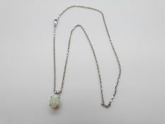 An 18ct white gold pendant set with an opal on 18ct white gold chain, 4.