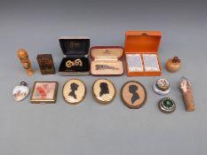 A collection of items including a scent bottle with a silver top, lucite compact,