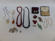A collection of silver jewellery, amber necklace, French jet necklace,