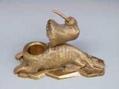 A 19thC bronze inkwell in the form of a walrus with hinged head,