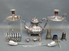A collection of plated ware including two chamber sticks, teapot, toast racks, salt,
